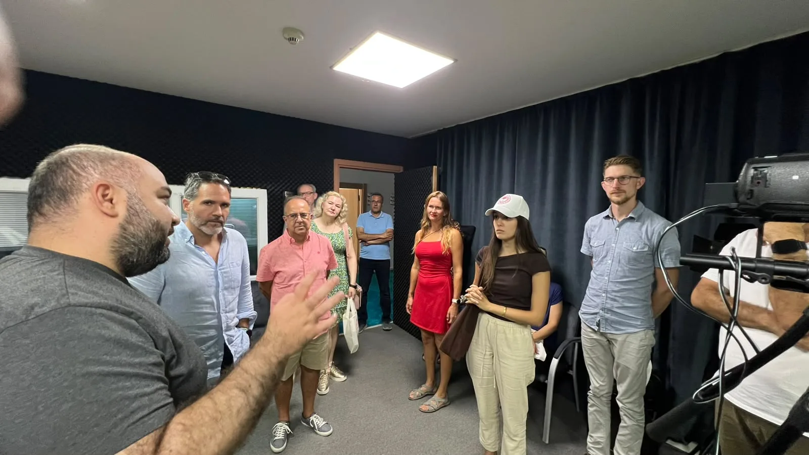 BeeBridge participants exchanging views beside a camera in Adana TAYEM's recording space