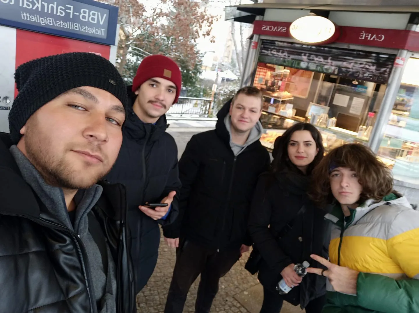Five participants taking a group selfie outdoors in Berlin