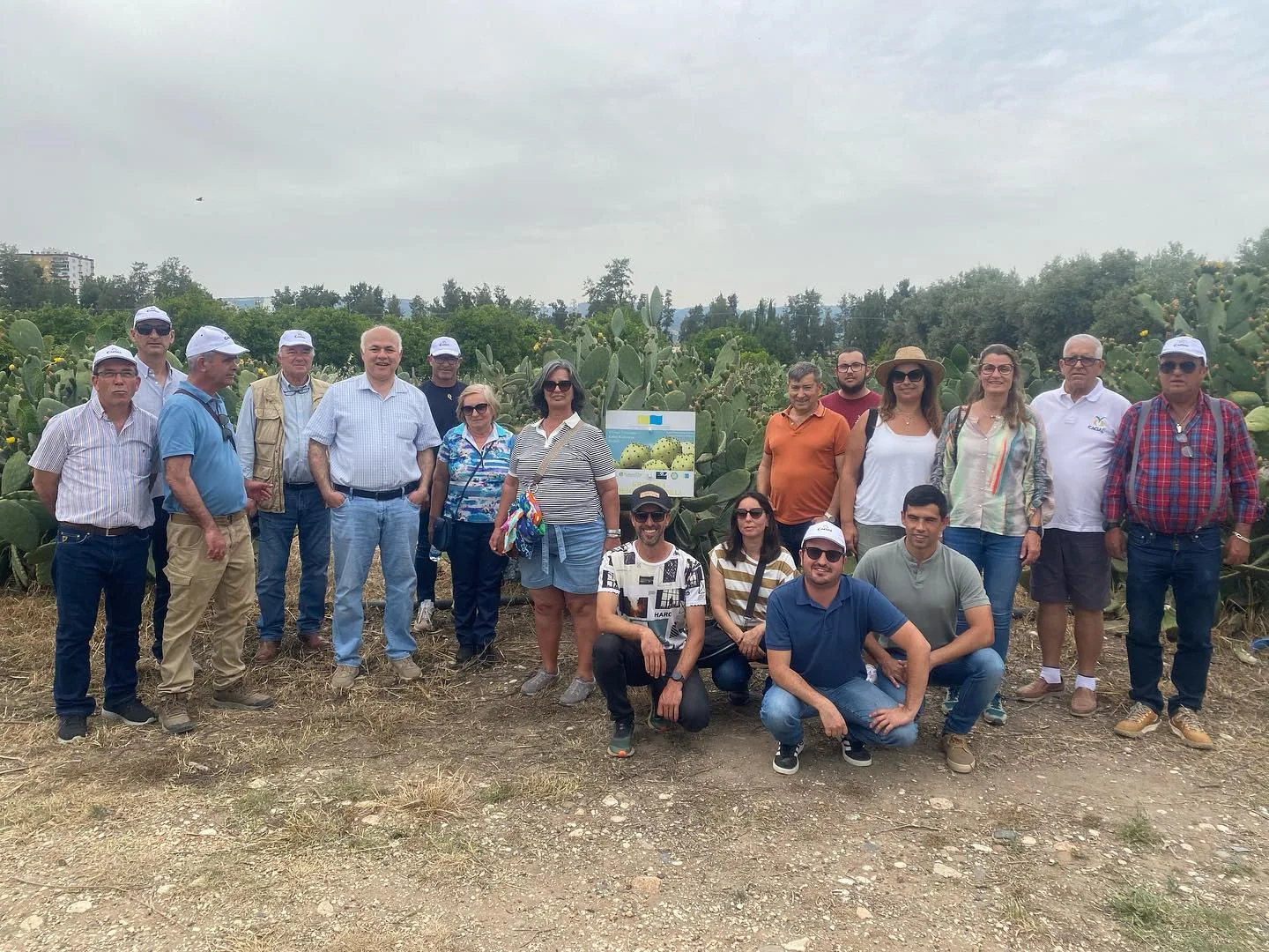 The group gathered in front of prickly pear plants during the meeting with the CACIAL delegation