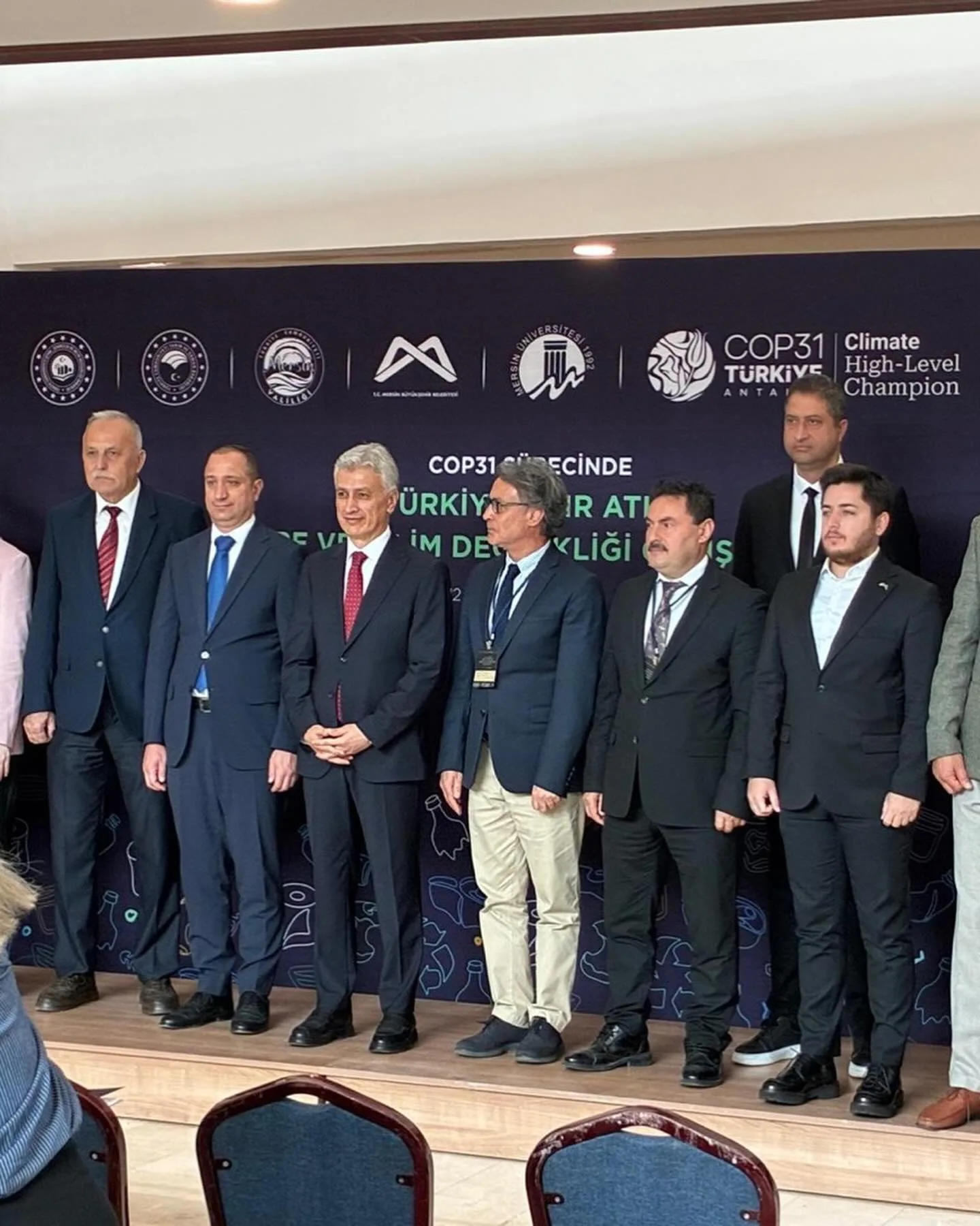 A group photograph in front of the Zero Waste, Environment and Climate Change Workshop backdrop in Mersin