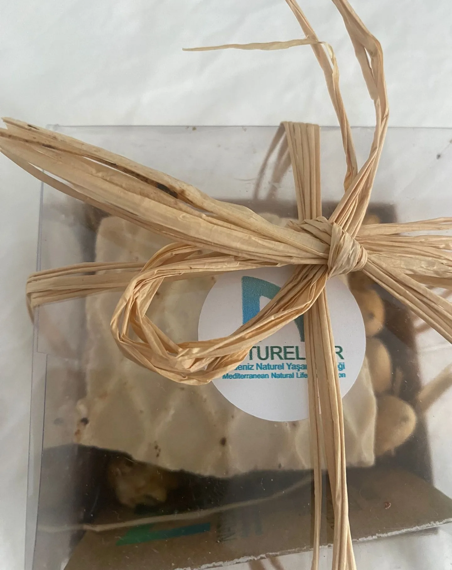Soap in a transparent box with a NATURELDER label, tied with raffia